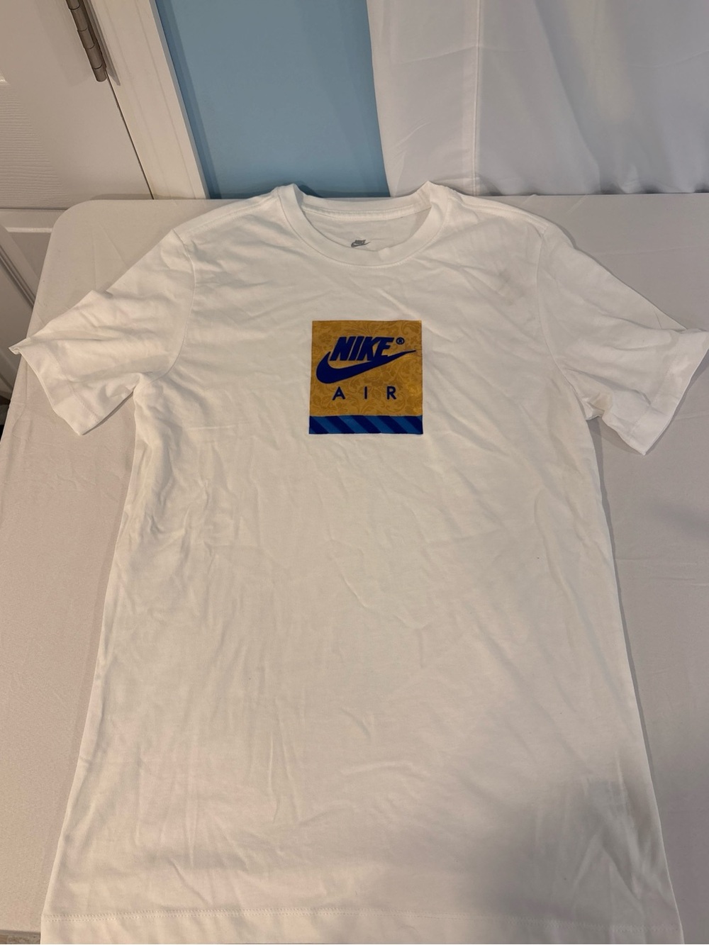 Nike White T-Shirt with Gold Square and Blue Logo